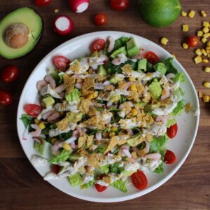 tex mex salad topped with crushed tortilla chips and healthy creamy dressing