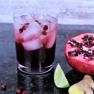 Pomegranate juice, gin, seltzer, ginger, lime, and arils (pomegranate seeds) gives this cocktail it's beautiful color.
