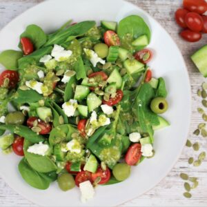 spinach salad with pesto dressing plated