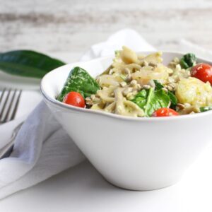 Healthy creamy pesto shrimp pasta in a white bowl