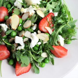easy peasy arugula salad with fresh straberries, goat cheese, peas, and almonds