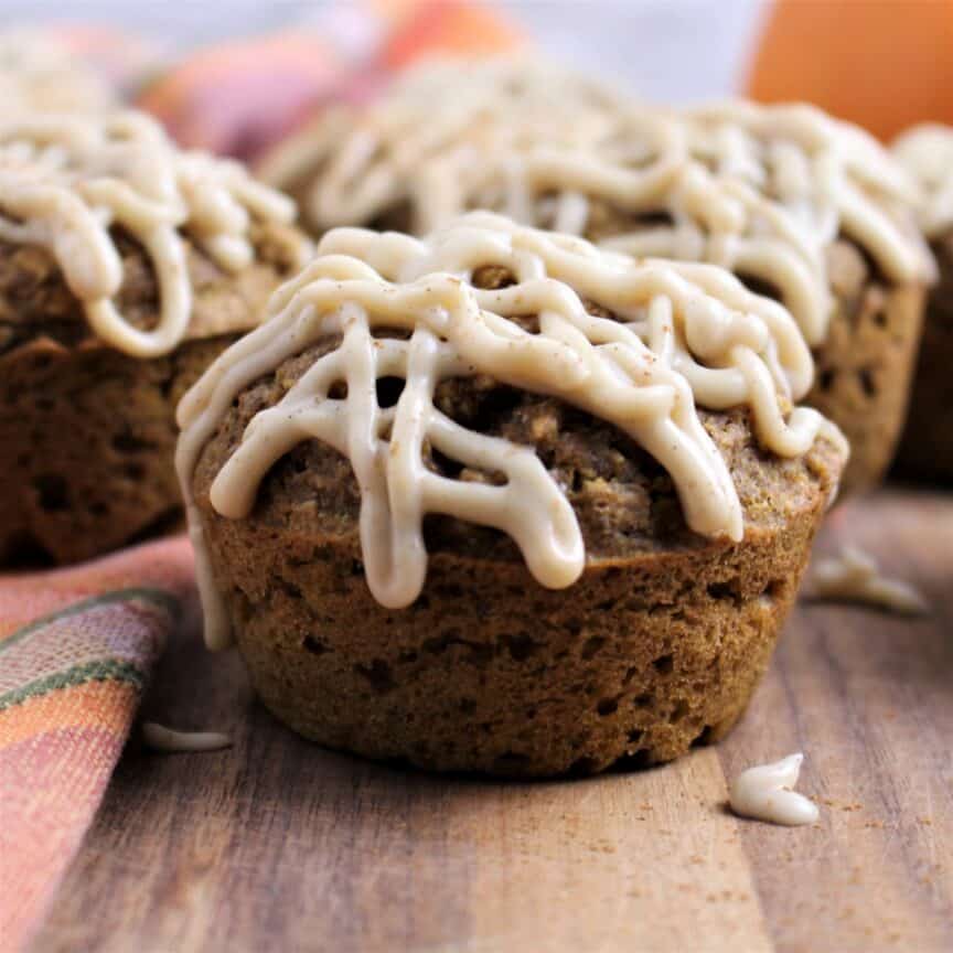 healthy pumpkin muffin drizzled with maple cream cheese glaze