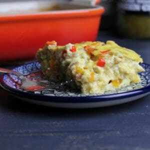 A close-up view of Green Chili Crustless quiche, plated, and beautifully speckled with colorful veggies