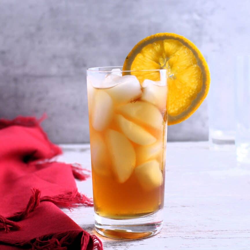 Fireball iced tea with an orange wheel slice for garnish.