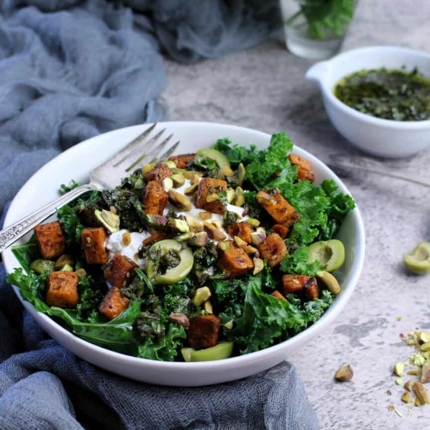 Vibrant kale lightly sautéed topped with roasted sweet potatoes, Greek yogurt, olives, and pistachios.