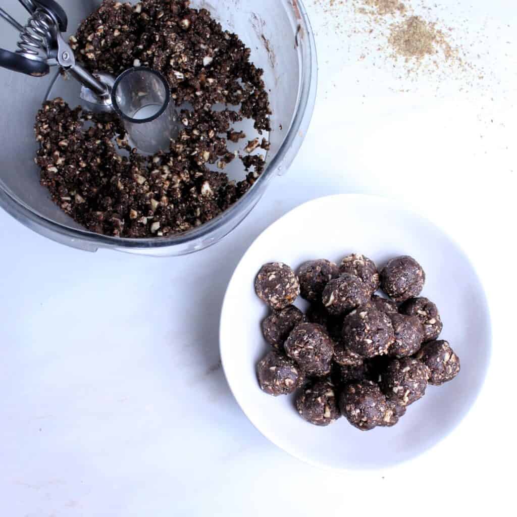 Scooping date mixture and rolling into balls.